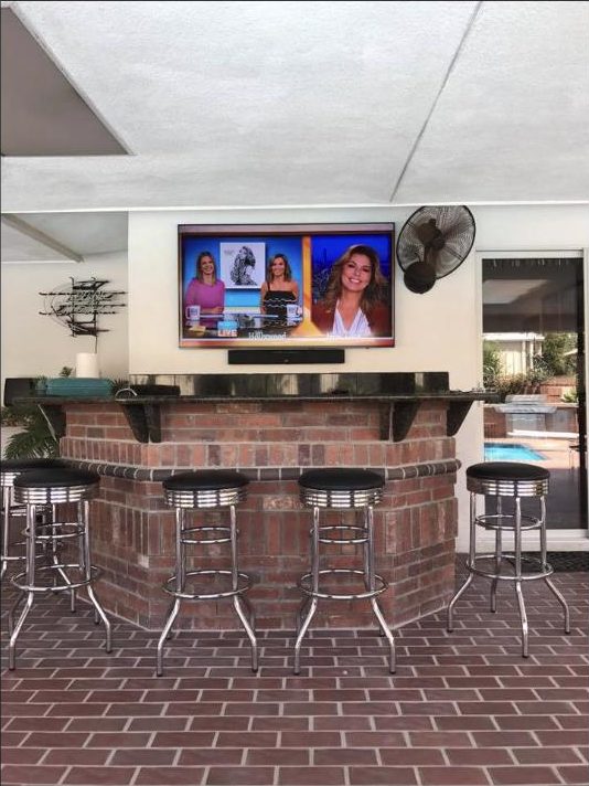 Outdoor TV installed at a pool bar by Kalieb Designs